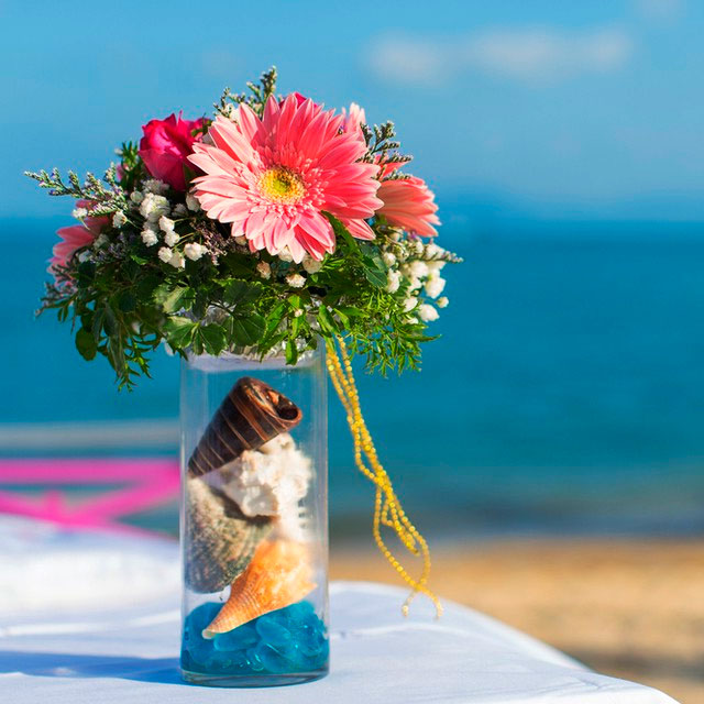 Detalle de florero con colores intensos para boda en la playa